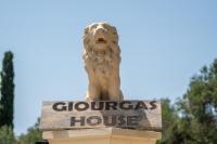 a statue of a lion on top of a gorgas house sign at Giourgas house in Chlomatianá