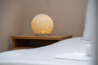a lamp sitting on a table next to a bed at Giourgas house in Chlomatianá