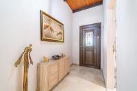 a hallway with a door and a painting on the wall at Giourgas house in Chlomatianá