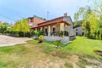 a house with a green yard in front of it at Giourgas house in Chlomatianá