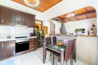 a kitchen with a table and chairs in a room at Giourgas house in Chlomatianá