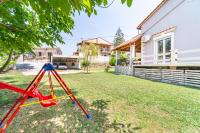 a swing set in the yard of a house at Giourgas house in Chlomatianá