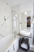 a white bathroom with a sink and a tub at Jardin de Villiers in Paris