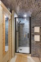 a bathroom with a shower with a glass door at Jardin de Villiers in Paris