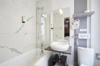 a white bathroom with a sink and a mirror at Jardin de Villiers in Paris