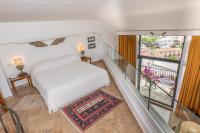 a bedroom with a white bed and a balcony at Hotel Poseidon in Positano