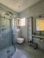 a bathroom with a toilet and a glass shower at Villa à 10m de la plage de sable in Vallauris