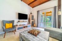 a living room with a chess board on a table at Giourgas house in Chlomatianá