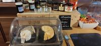 a sandwich in a plastic container on a table with a sandwich at Logis Le Saint Hubert in Haybes