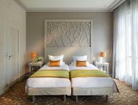 a bedroom with two beds with orange pillows at Splendid Etoile in Paris