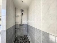 a bathroom with a shower with a black and white tiles at 2948-Maison 8 couchages 600m de la mer in Saint-Cyprien
