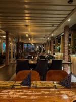 a restaurant with tables and chairs and a bar at Hotel Schlossblick Chiemsee in Prien am Chiemsee