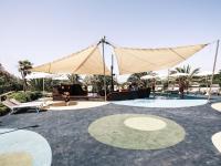 a pool with a tent and a table and chairs at Falkensteiner Family Hotel Diadora in Zadar
