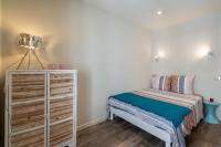 a small bedroom with a bed and a dresser at Standing Vieux port 110 m2, Marseille in Marseille