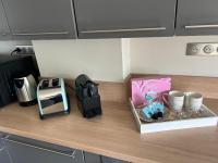 a kitchen counter with a coffee maker and cups on it at Standing Vieux port 110 m2, Marseille in Marseille