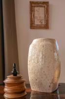 a stone vase sitting on top of a table at Surplage Hotel Cavalière in Le Lavandou