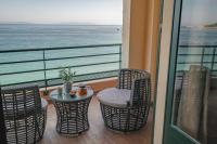 a balcony with a table and chairs and the ocean at Surplage Hotel Cavalière in Le Lavandou