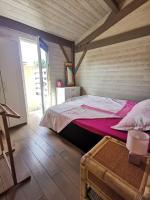 a bedroom with a bed in a wooden room at MAISON &amp; PISCINE PRIVES,PLAGES OCEAN ET LAC A 10 kms in Linxe