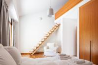 a white room with a staircase and a white chair at Angels Villa in Kambánion