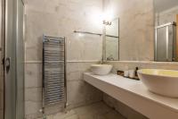 a bathroom with two sinks and a mirror at Angels Villa in Kambánion