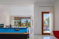 a living room with a pool table in front of a door at Angels Villa in Kambánion