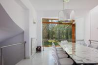a dining room with a glass table and white chairs at Angels Villa in Kambánion