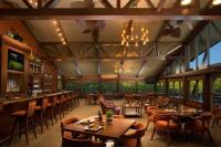 a restaurant with tables and chairs and a bar at Early check in- late check out Free day! in Lake Geneva