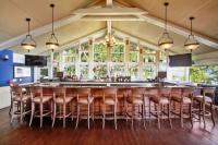 a bar with a bunch of stools in a room at Early check in- late check out Free day! in Lake Geneva