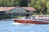 a boat in the water in front of a building at Early check in- late check out Free day! in Lake Geneva
