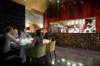 a group of people sitting at a table in a restaurant at Aria Hotel Budapest by Library Hotel Collection in Budapest