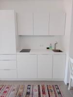 a white kitchen with a sink and white cabinets at Storchencamp Gästehaus Purbach in Purbach am Neusiedlersee
