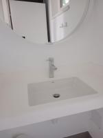 a white bathroom with a sink and a mirror at Storchencamp Gästehaus Purbach in Purbach am Neusiedlersee