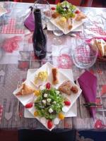 a table with plates of food and a bottle of wine at Bateau Mariance in Ginestas