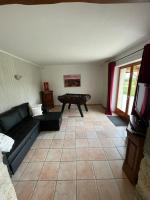 a living room with a couch and a table at le Pigeonnier gersois in Condom