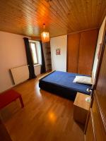 a bedroom with a blue bed and a wooden ceiling at le Pigeonnier gersois in Condom