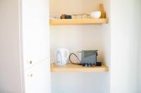 a kitchen with a shelf with a appliance on it at Le Mucem du Vieux Port in Marseille