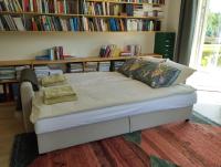 a bed in a room with a book shelf at Susimetsa 
