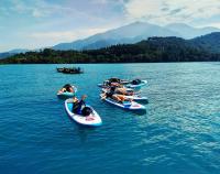 a group of people laying on kayaks in the water at 水社海民宿 in Yuchi