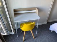 a yellow chair sitting next to a desk at *Le Baudin : T2 cosy vue dégagée in Limoges