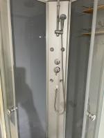 a shower in a bathroom with a glass door at *Le Baudin : T2 cosy vue dégagée in Limoges