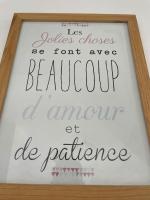 a sign in a wooden frame with writing on it at *Le Baudin : T2 cosy vue dégagée in Limoges