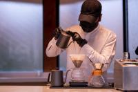 a man in a mask is making a blender at Meral Oasis Resort Taif in Taif