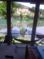 a hammock in a room with a view of a river at Vikendica pored Drine Foča in Handići