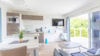 a kitchen and living room in a tiny house at Le Theven in Sibiril