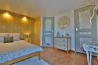 a bedroom with a bed and a dresser and a door at Gite de groupe &quot;L&#39;Unisson&quot; Domaine La Rose des Vents in Castelnau-sur-lʼAuvignon
