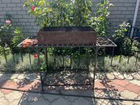 a planter with a plant on a stand in a garden at Barvy Dnipra in Dnipro
