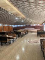 a dining room with tables and chairs and a ceiling at Bilal luxury camp in Wadi Rum