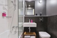 a bathroom with a sink and a shower and a toilet at Moxy Paris Bastille in Paris