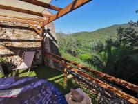 a room with a balcony with a view of the mountains at Maison Amandre en Pleine Nature - Mas Lou Castanea in Collobrières