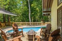 eine Terrasse mit zwei Stühlen und einem Swimmingpool in der Unterkunft Bourbon Hollow Lodge with Hot Tub and Pool plus Game Room only 5 min to downtown in Gatlinburg